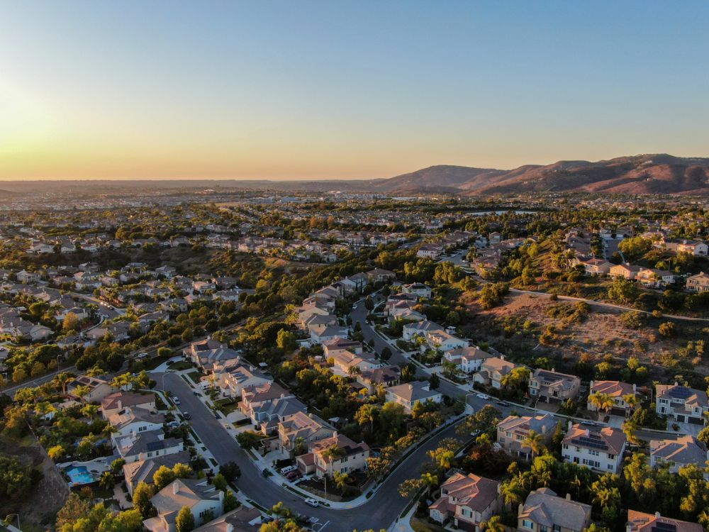 Aerial view of residential modern subdivision luxury house neighborhood during sunset